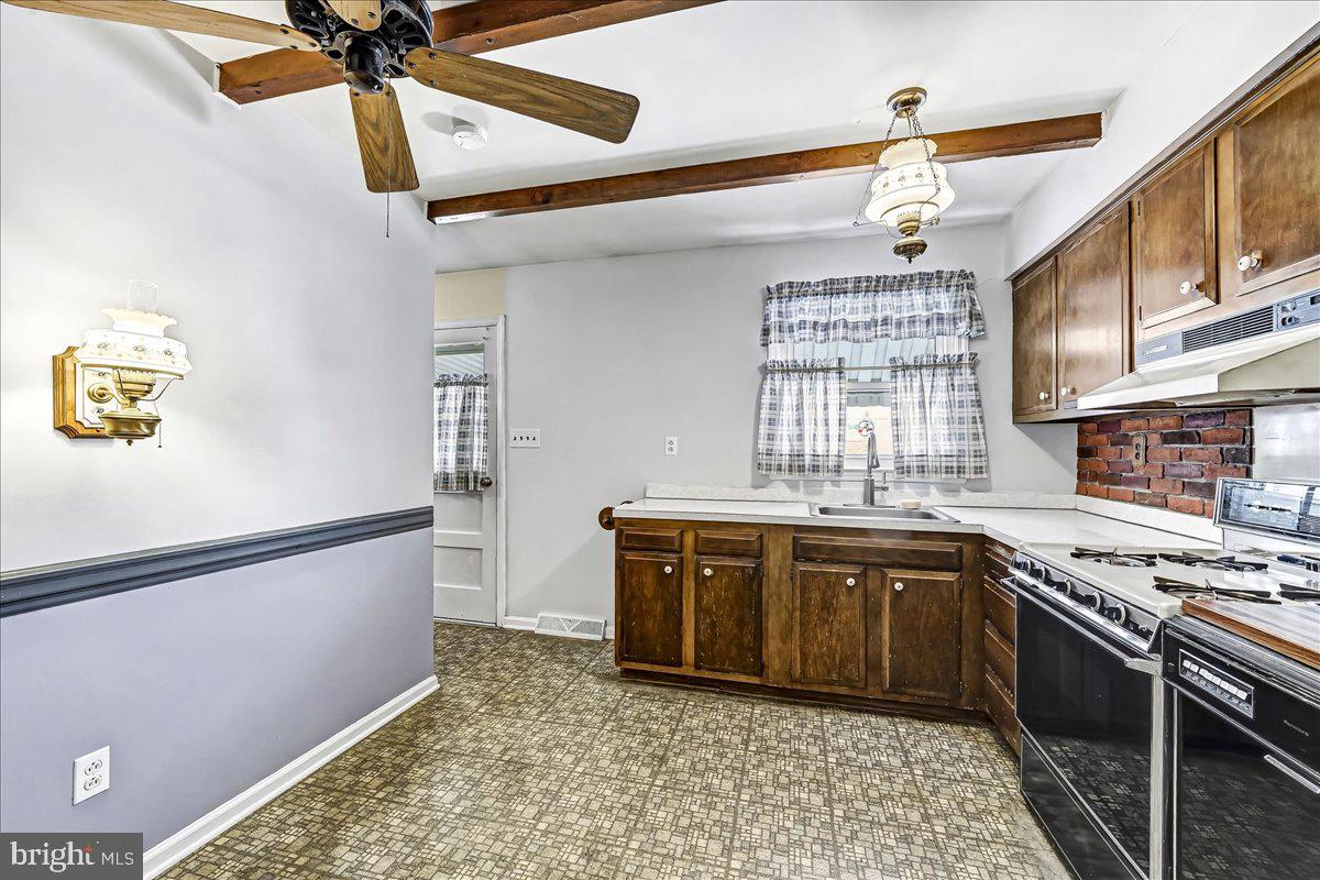 123 Reybold Drive Delaware City, DE 19706 - Photo 10 of 30 a kitchen with stainless steel appliances granite countertop a stove sink and cabinets