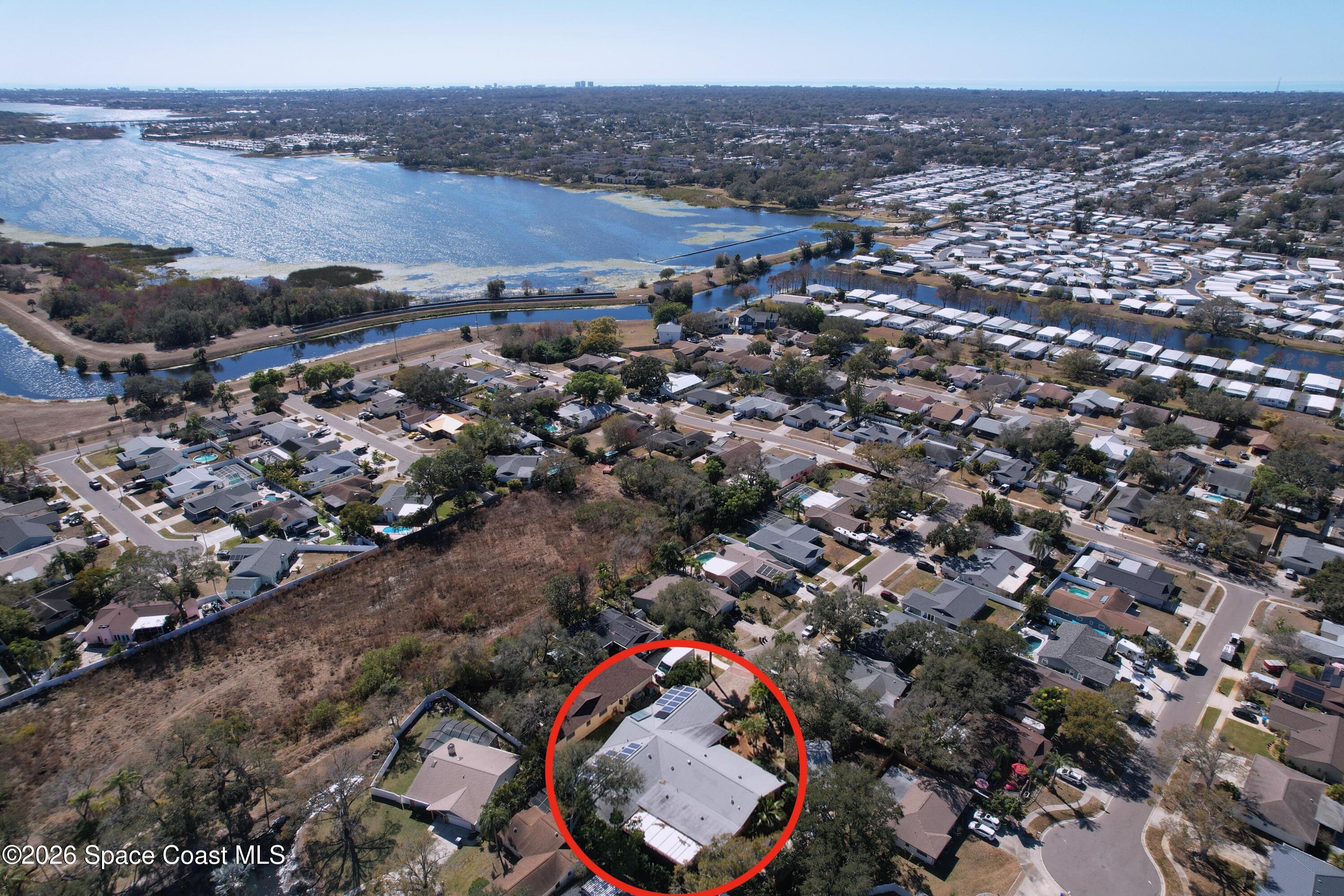 9591 128th Terrace North Largo, FL 33773 - Photo 2 of 90 an aerial view of a house with a yard and lake view