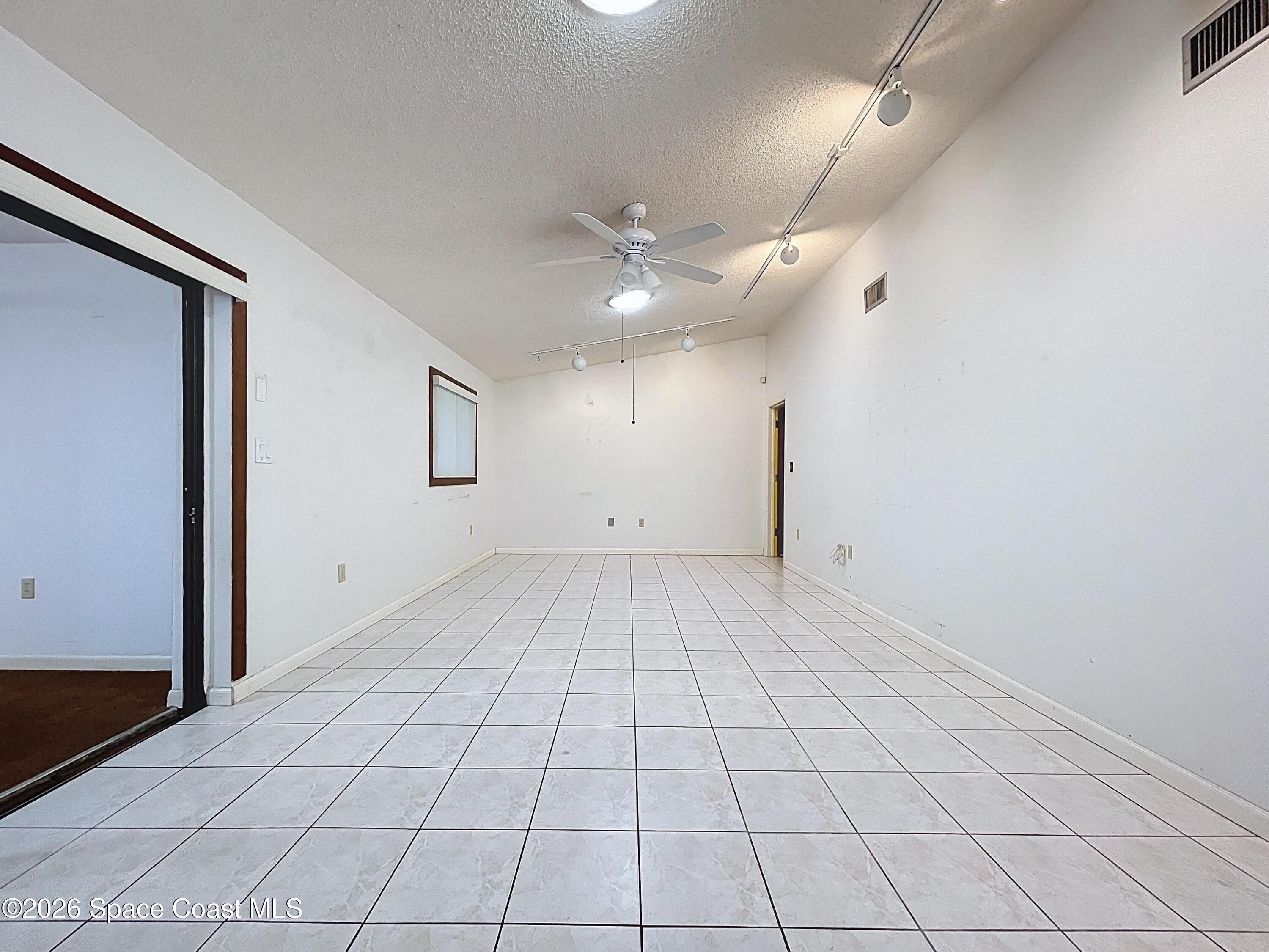 9591 128th Terrace North Largo, FL 33773 - Photo 40 of 90 en empty room with white walls and ceiling fan
