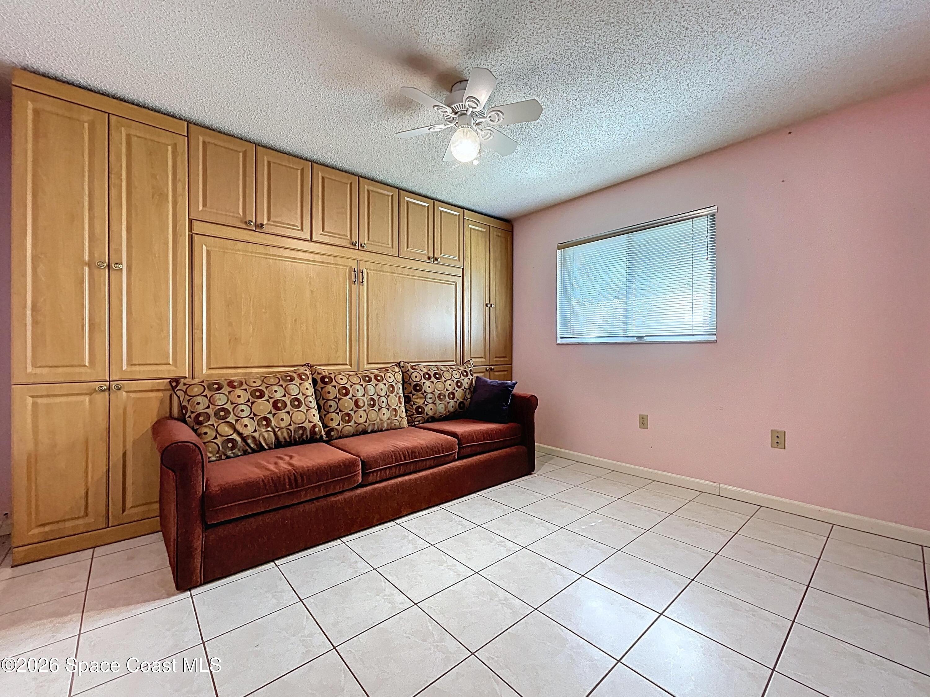 9591 128th Terrace North Largo, FL 33773 - Photo 65 of 90 a living room with furniture and a chandelier