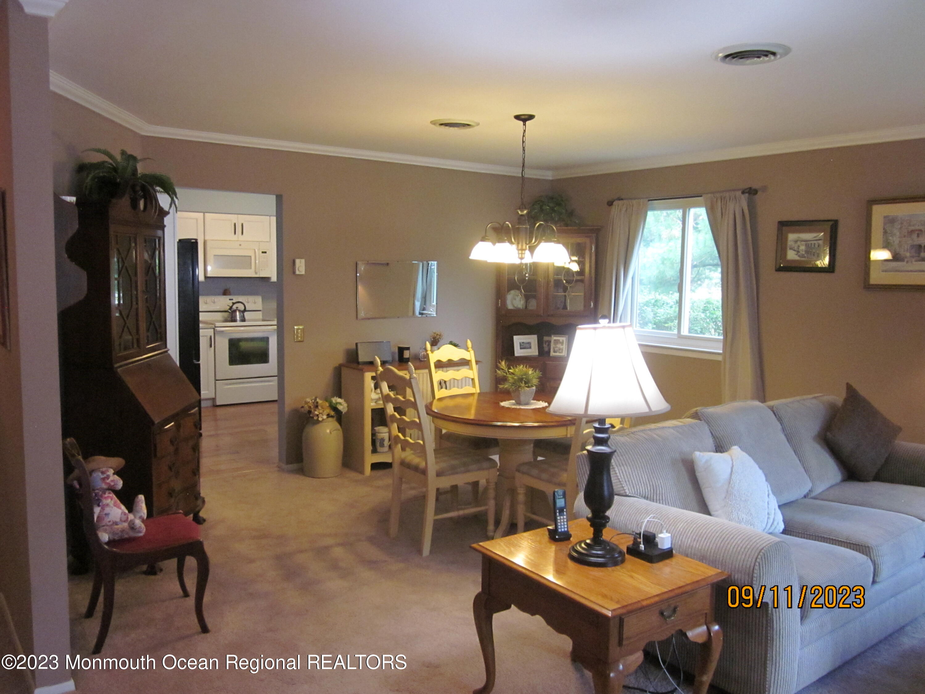 53 B Berkshire Road Whiting, NJ 08759 - Photo 12 of 37 a living room with furniture a chandelier and a dining table