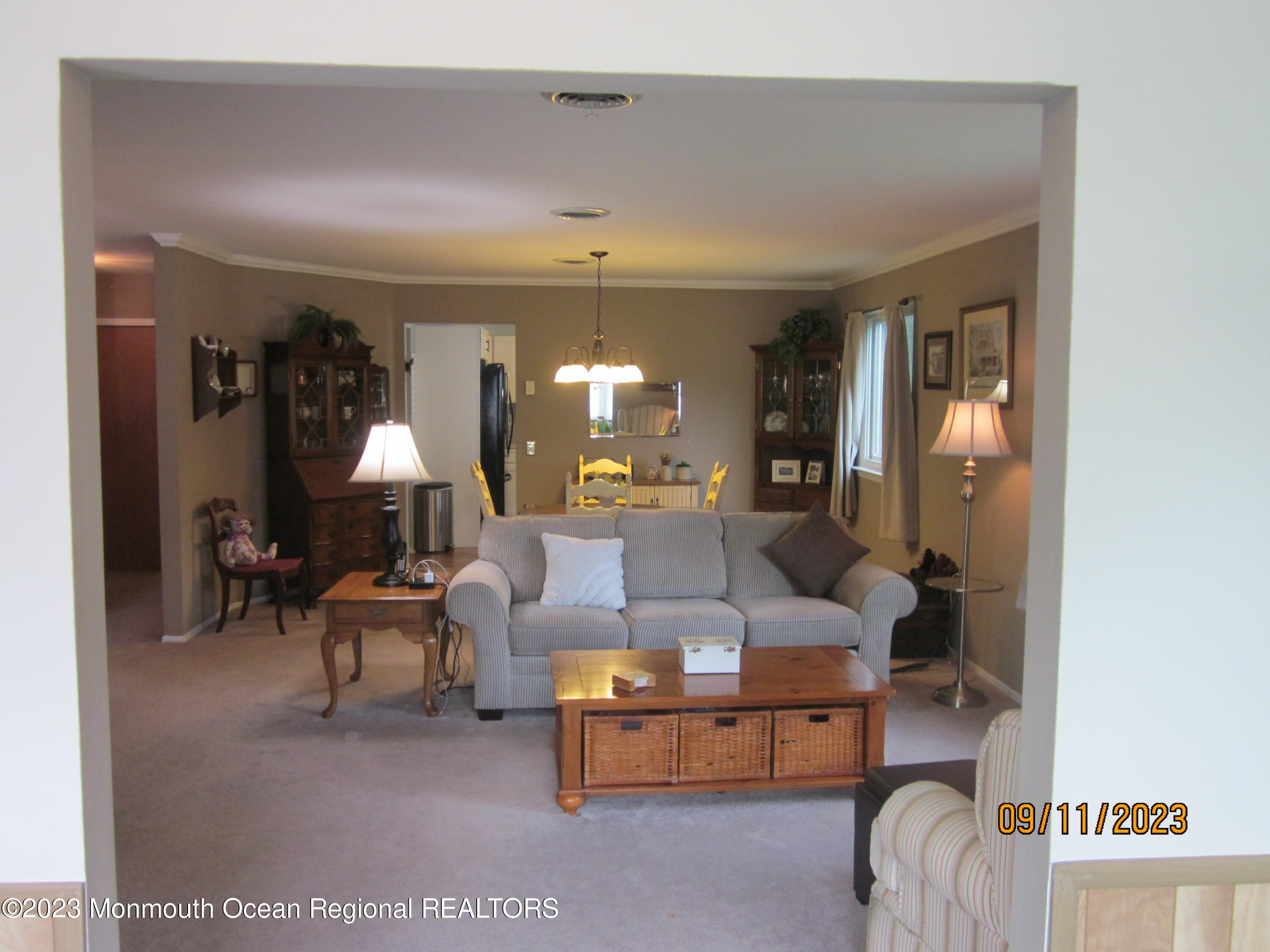 53 B Berkshire Road Whiting, NJ 08759 - Photo 8 of 37 a living room with furniture and a chandelier