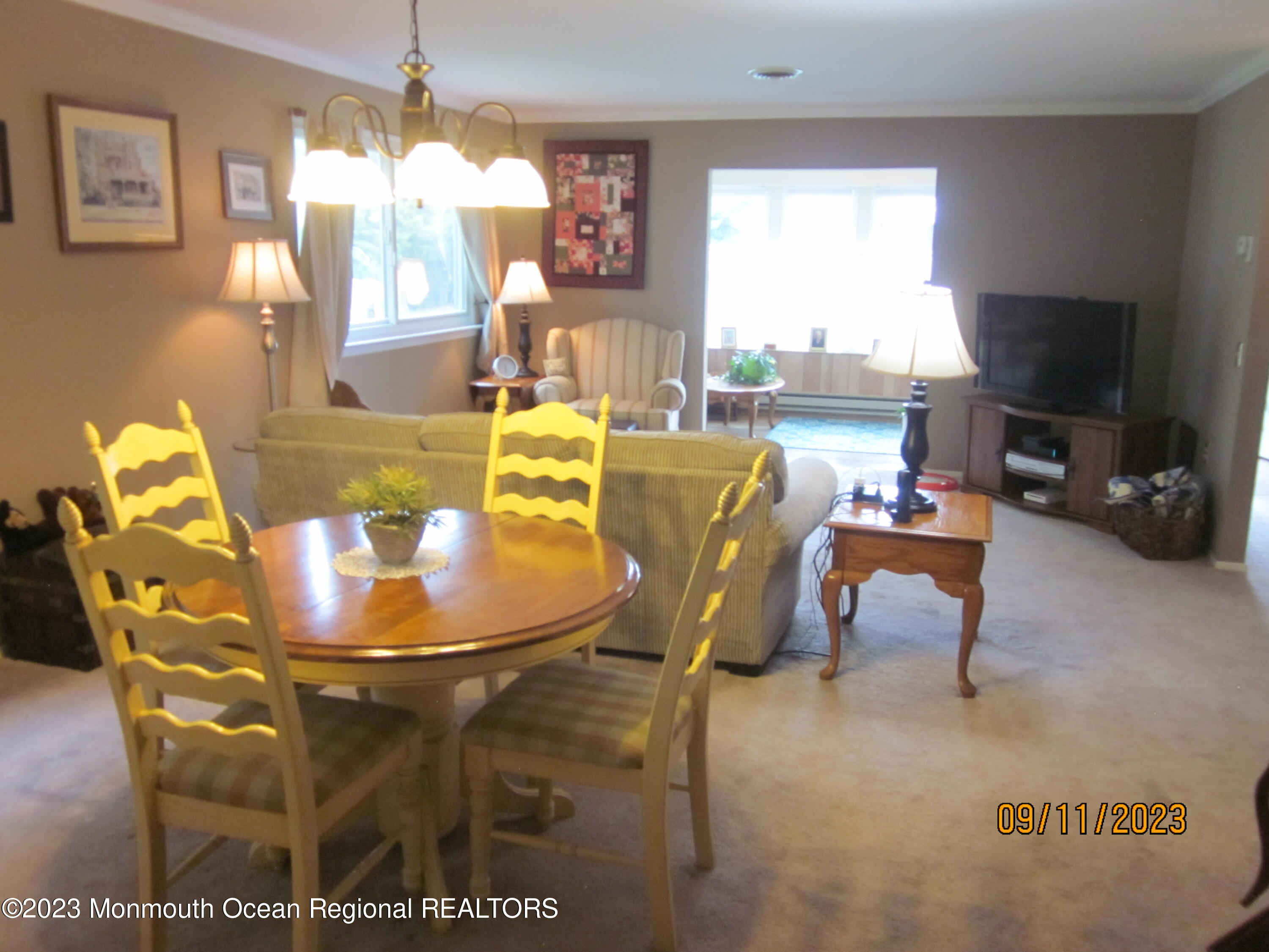53 B Berkshire Road Whiting, NJ 08759 - Photo 10 of 37 a dining room with furniture a flat screen tv and a large window