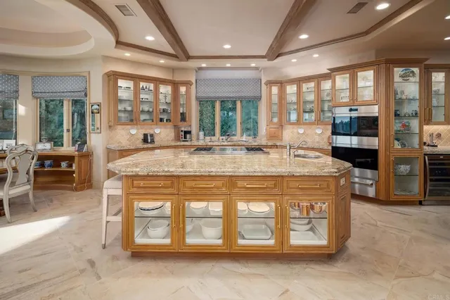 a living room with patio furniture and potted plants