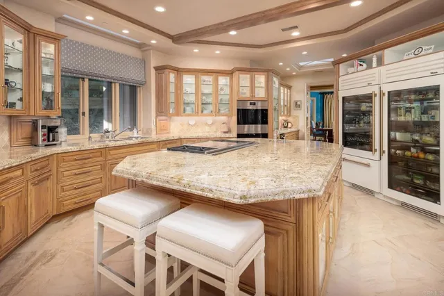 a view of a patio with couches table and chairs and potted plants