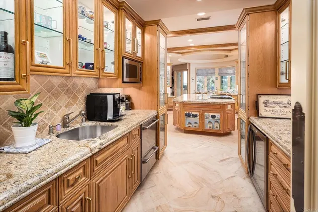 a living room with furniture fireplace and a large window