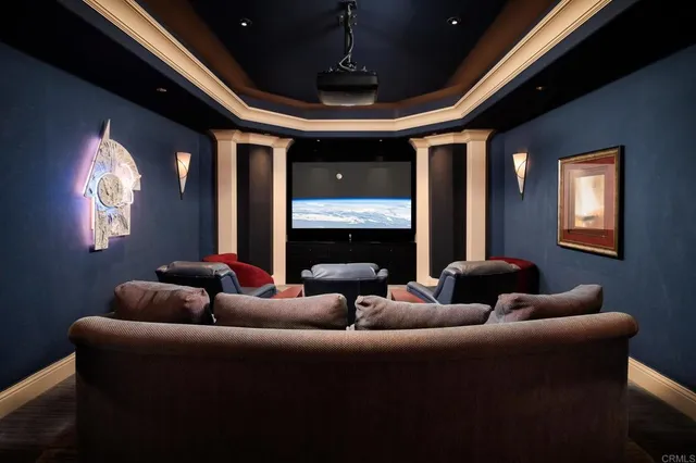 a view of a white house with a big yard and palm trees