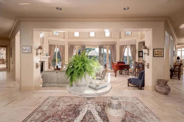 a view of a dining room with furniture and a chandelier