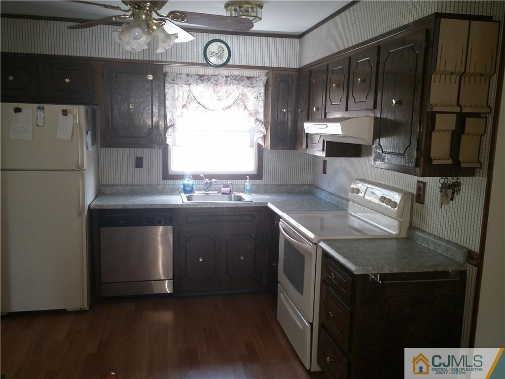 63 Enfield Road Colonia, NJ 07067 - Photo 11 of 17 a kitchen with stainless steel appliances granite countertop a sink a stove a refrigerator a cabinets and wooden floor