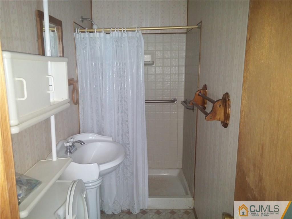 63 Enfield Road Colonia, NJ 07067 - Photo 13 of 17 a bathroom with a shower and toilet