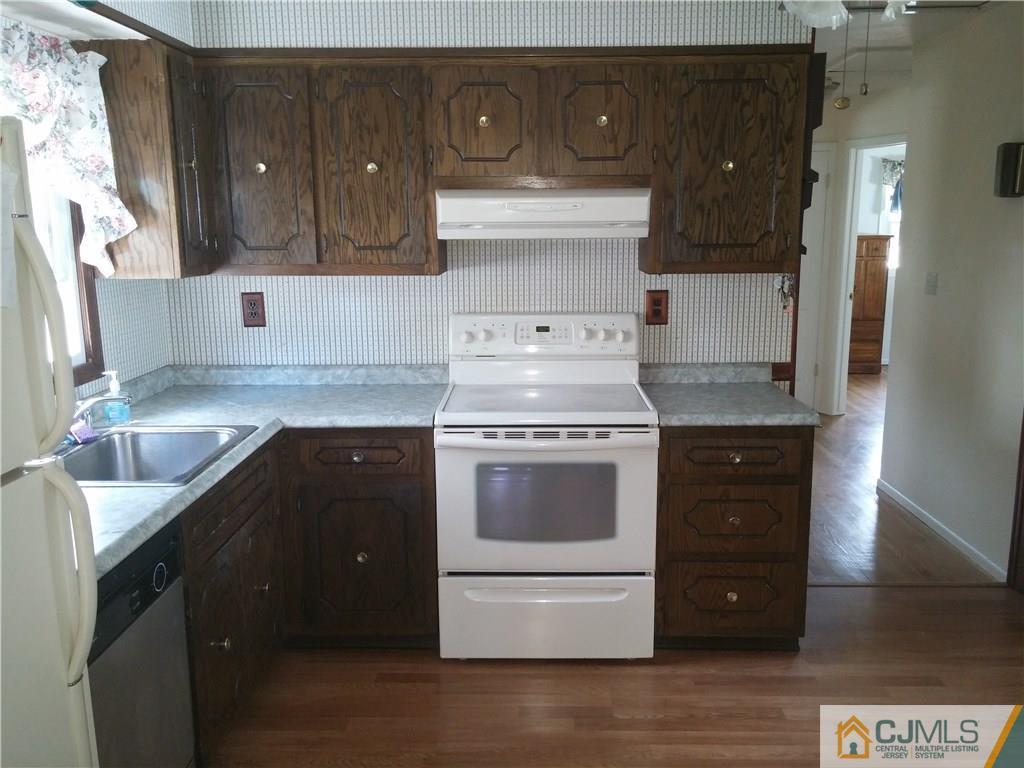 63 Enfield Road Colonia, NJ 07067 - Photo 5 of 17 a kitchen with stainless steel appliances granite countertop a stove and a refrigerator