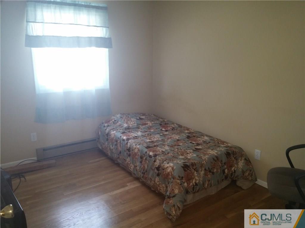 63 Enfield Road Colonia, NJ 07067 - Photo 10 of 17 a bedroom with a bed and a window