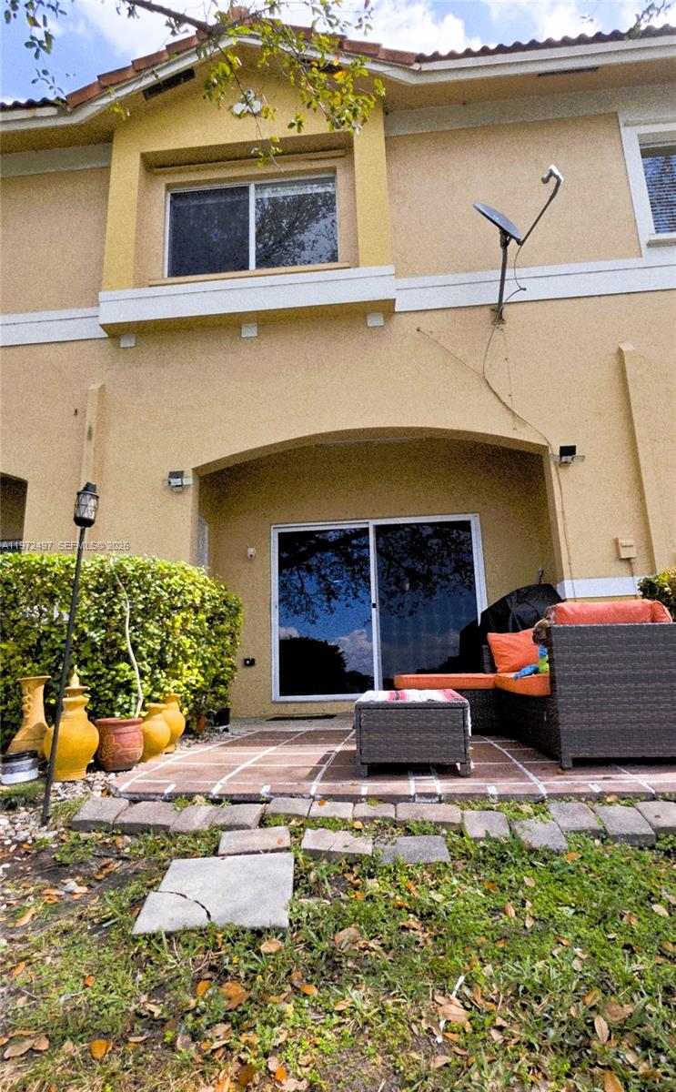 5937 Riverside Avenue Tamarac, FL 33321 - Photo 12 of 31 a front view of a house with a yard