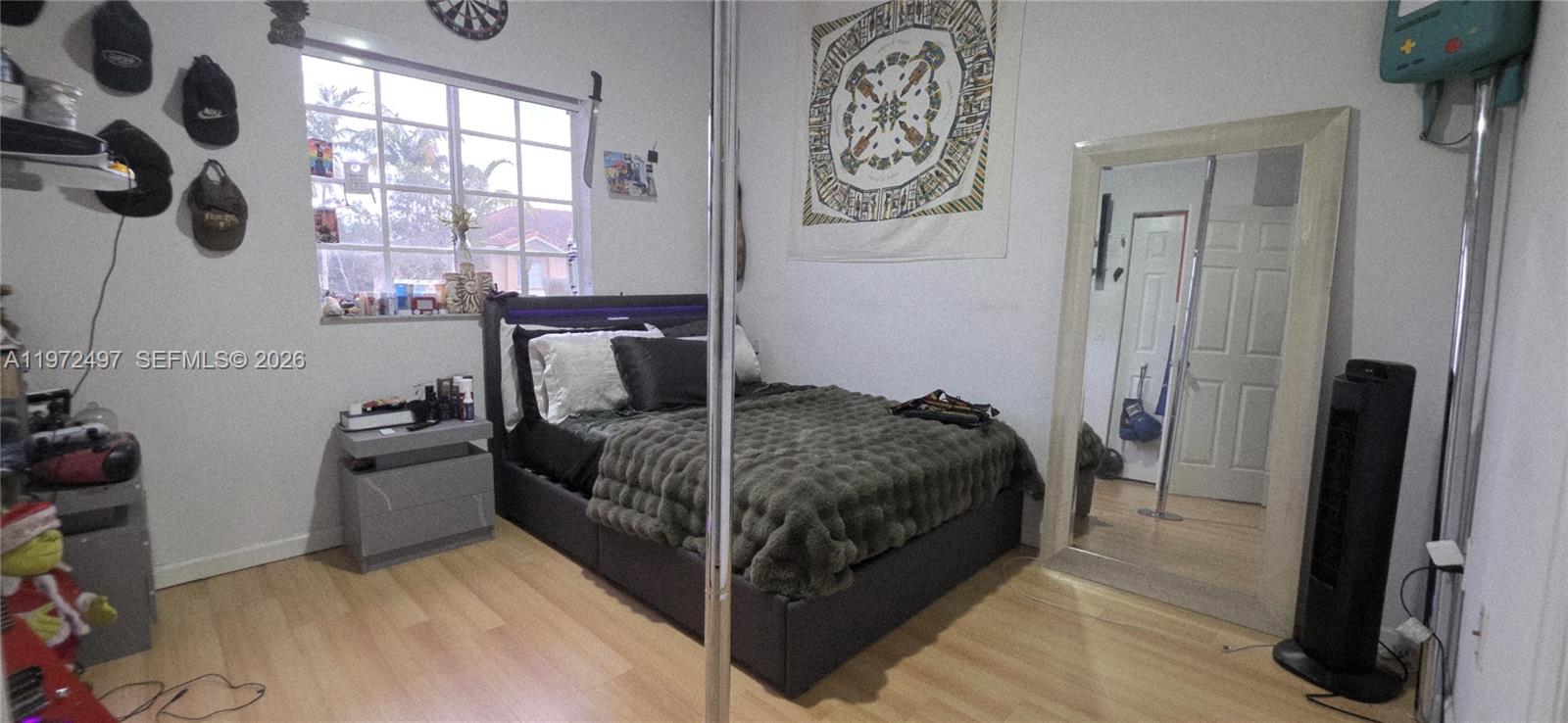 5937 Riverside Avenue Tamarac, FL 33321 - Photo 17 of 31 a bedroom with a bed and a window