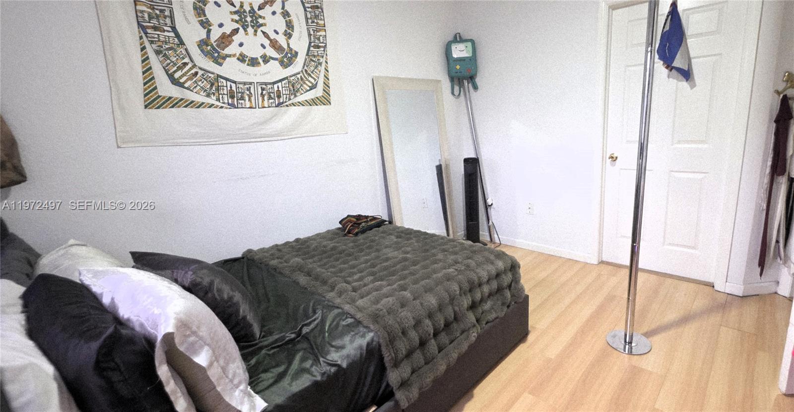 5937 Riverside Avenue Tamarac, FL 33321 - Photo 18 of 31 a bedroom with a bed and a walk in closet