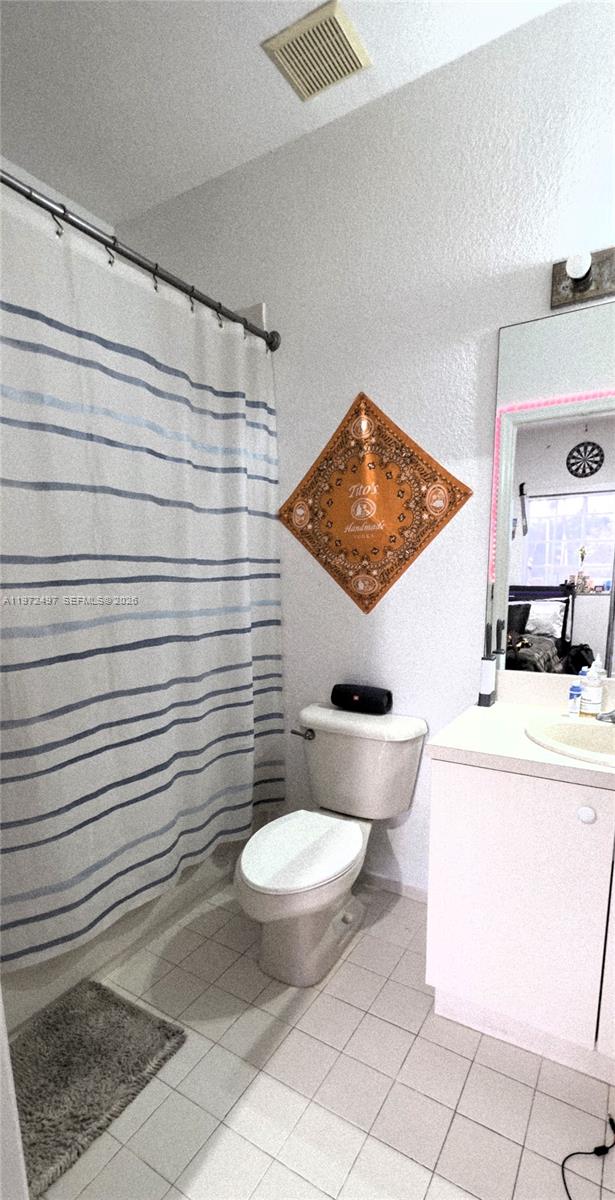 5937 Riverside Avenue Tamarac, FL 33321 - Photo 19 of 31 a bathroom with a toilet and a shower