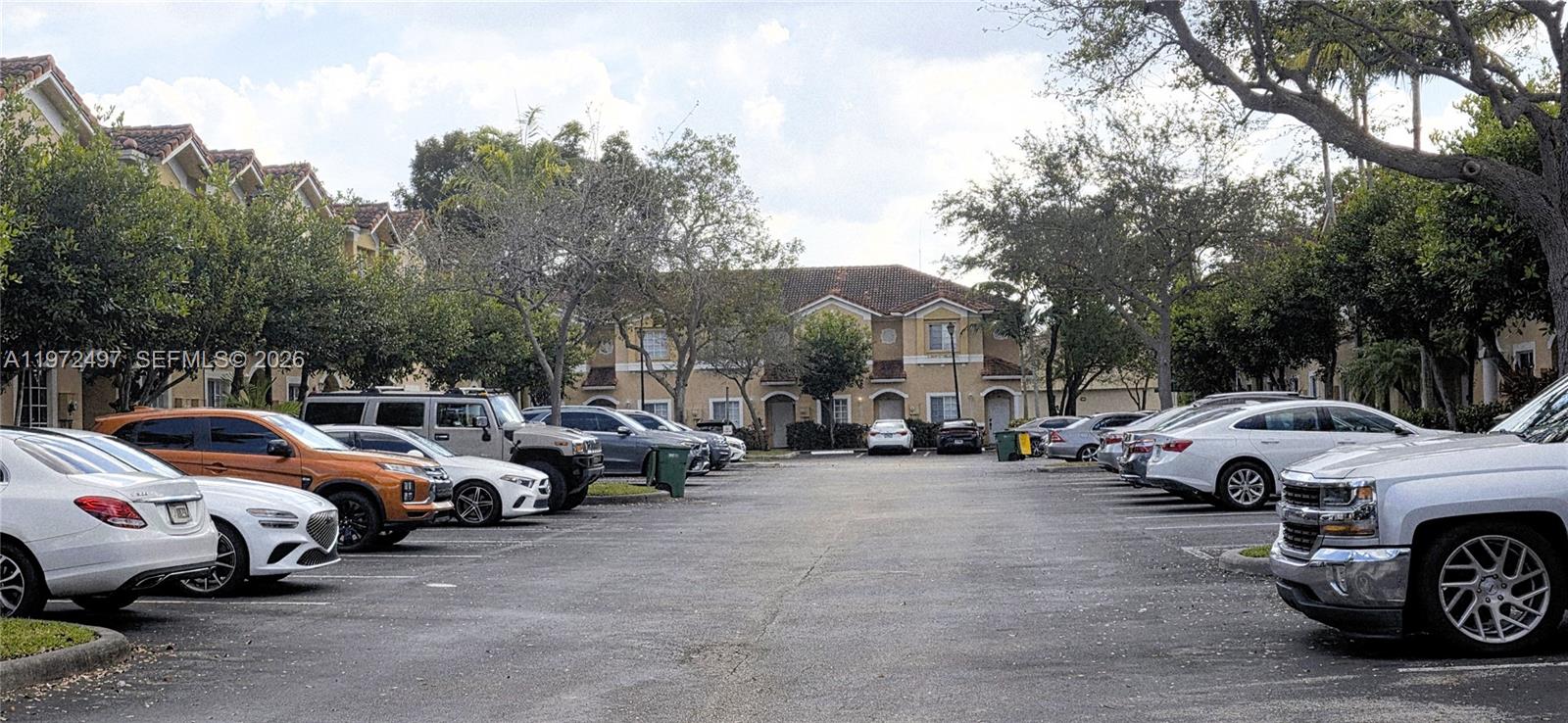 5937 Riverside Avenue Tamarac, FL 33321 - Photo 2 of 31 a group of cars parked in a parking lot at street side