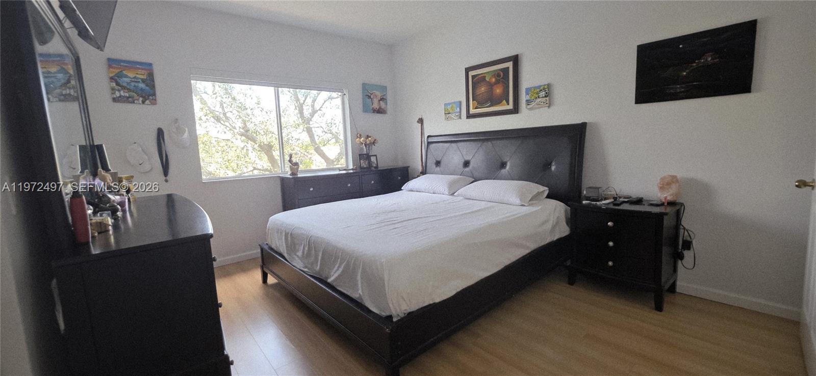 5937 Riverside Avenue Tamarac, FL 33321 - Photo 21 of 31 a bedroom with a bed and a flat screen tv