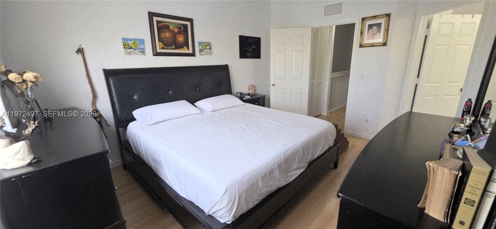 5937 Riverside Avenue Tamarac, FL 33321 - Photo 23 of 31 a bedroom with a bed and a table