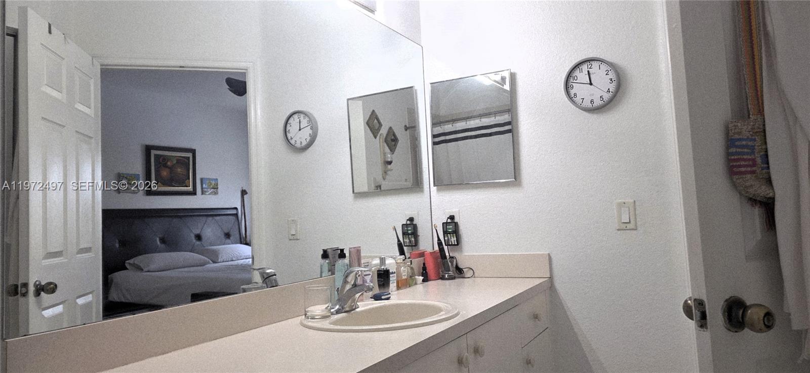 5937 Riverside Avenue Tamarac, FL 33321 - Photo 25 of 31 a bathroom with a granite countertop sink and a mirror