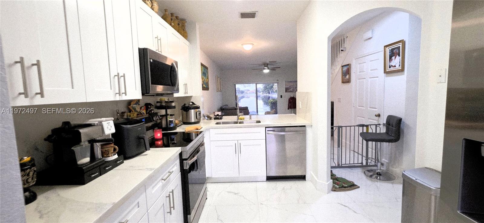 5937 Riverside Avenue Tamarac, FL 33321 - Photo 5 of 31 a kitchen with a sink appliances and cabinets
