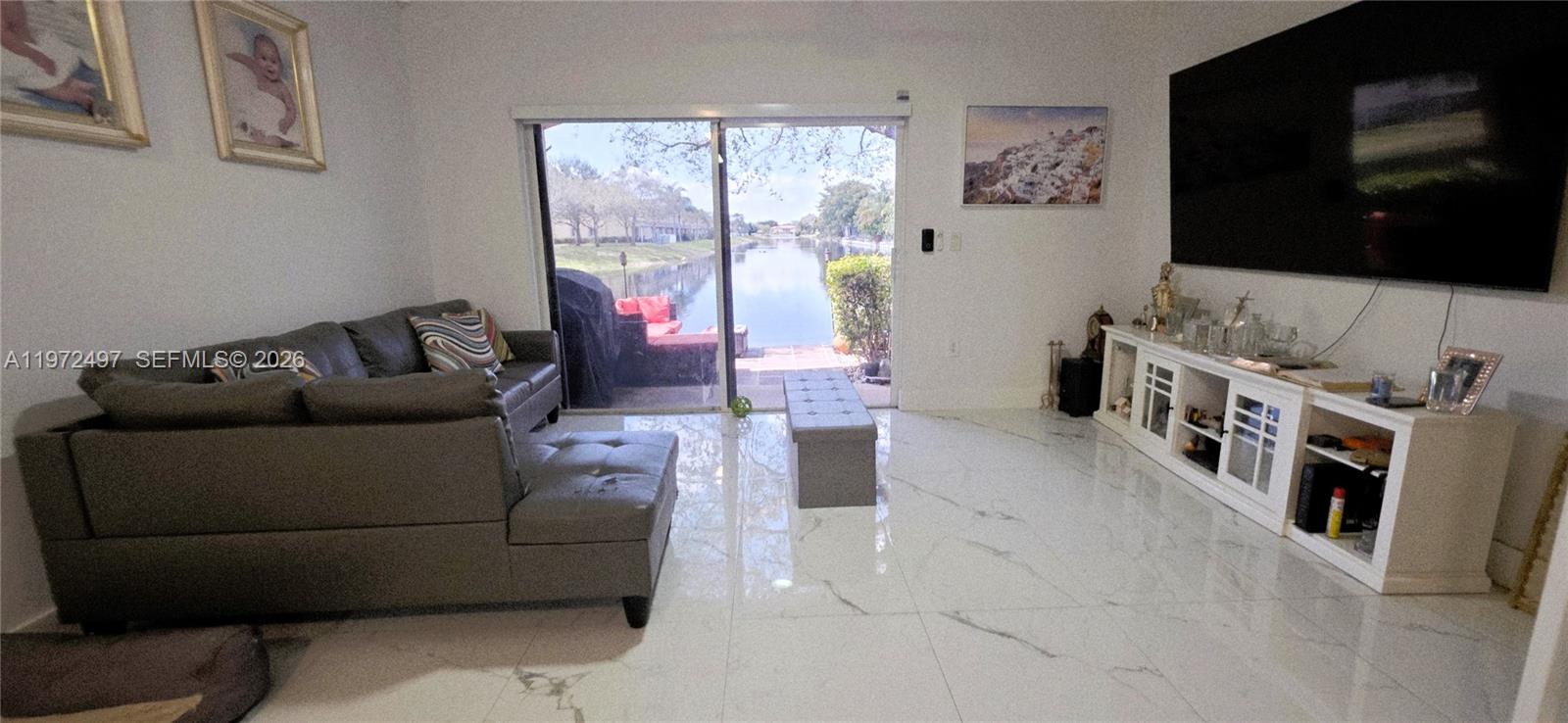 5937 Riverside Avenue Tamarac, FL 33321 - Photo 8 of 31 a living room with furniture and a flat screen tv