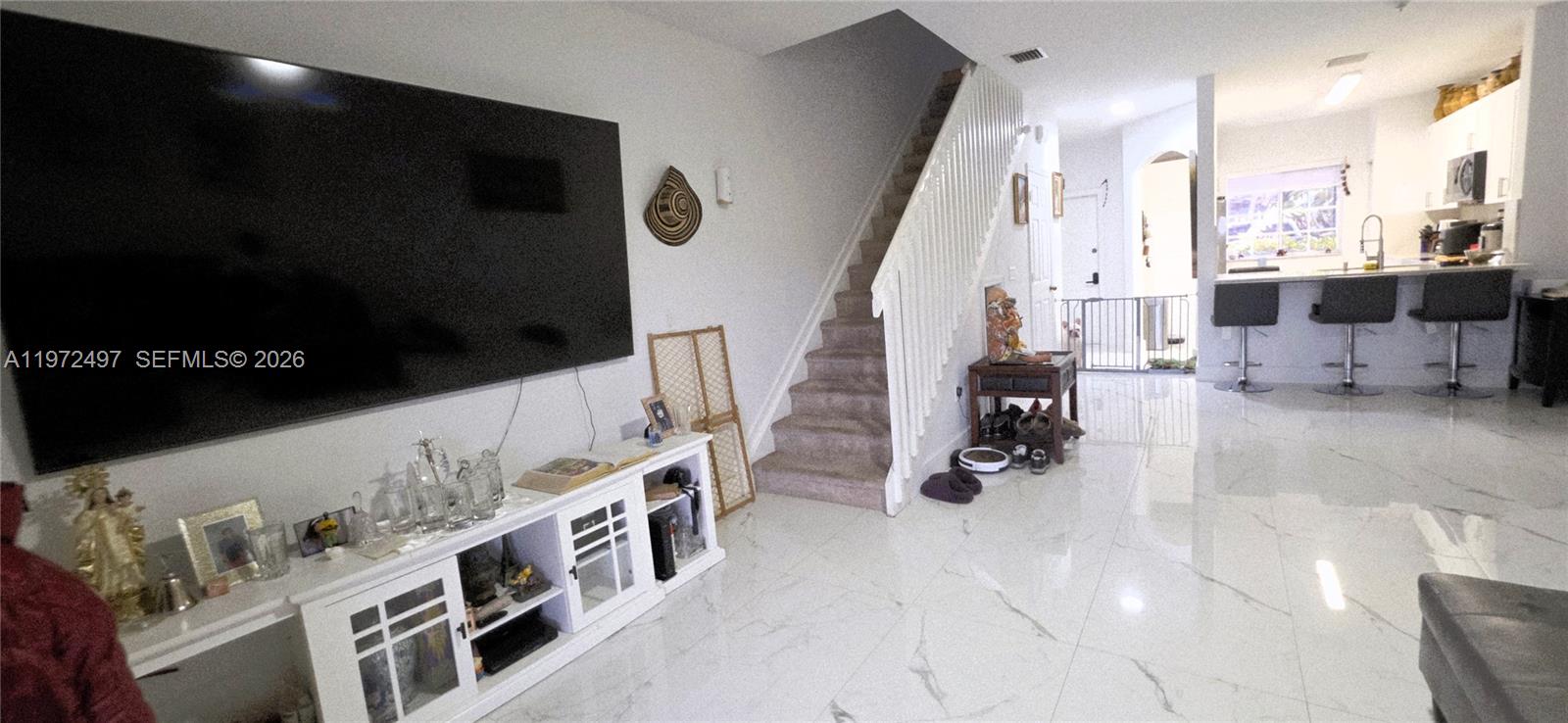 5937 Riverside Avenue Tamarac, FL 33321 - Photo 9 of 31 a living room with furniture and a flat screen tv