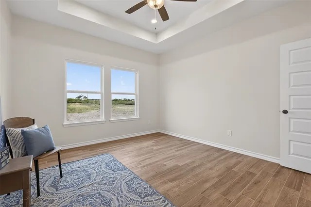 a view of room with window and wooden floor