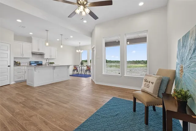 a view of a kitchen with furniture and a wooden floor