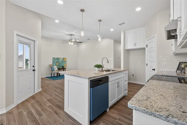 a kitchen with a stove and a sink
