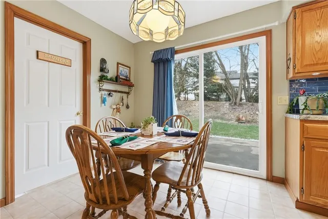 a dining room with furniture a flat screen tv and a large window