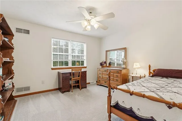 a bedroom that has a bed and a table in it