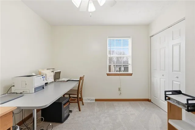 a view of a workspace with furniture and window