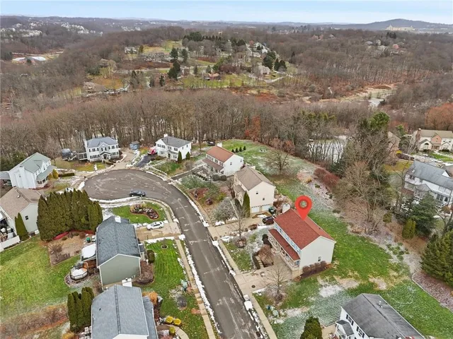 an aerial view of a house with yard swimming pool and lake view