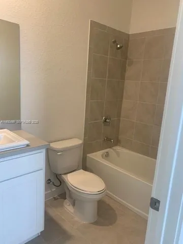 a bathroom with a toilet a sink and bathtub
