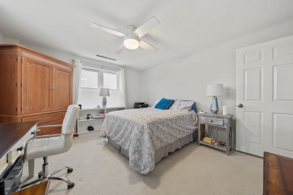 20 Rockland House Road, Unit 406 Hull, MA 02045 - Photo 19 of 39 a bedroom with a bed and a chandelier