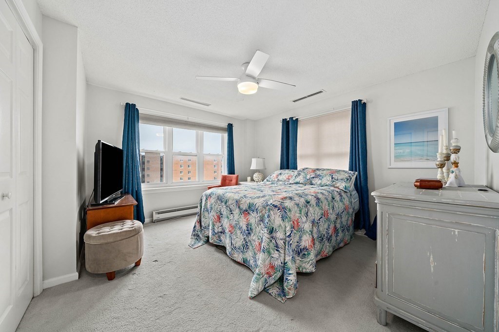 20 Rockland House Road, Unit 406 Hull, MA 02045 - Photo 21 of 39 a bedroom with a bed and a flat screen tv