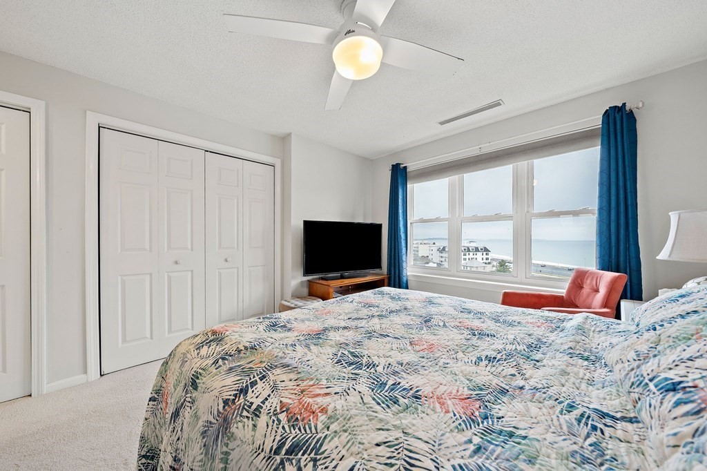 20 Rockland House Road, Unit 406 Hull, MA 02045 - Photo 22 of 39 a bedroom with a bed and glass window
