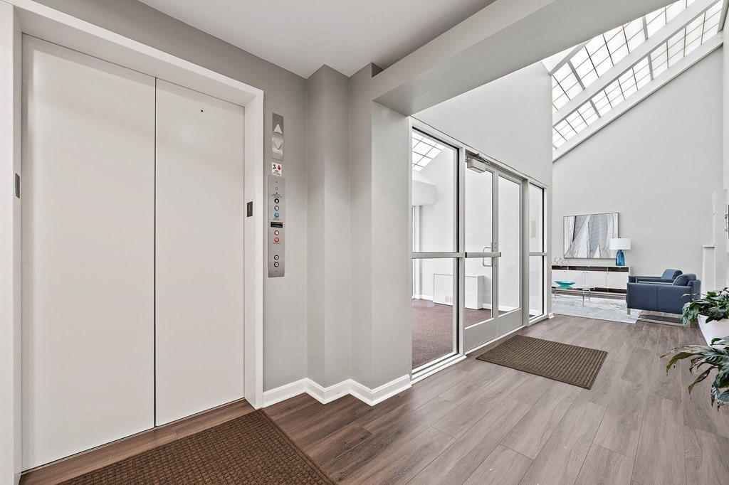 20 Rockland House Road, Unit 406 Hull, MA 02045 - Photo 3 of 39 a view of a room with wooden floor and windows
