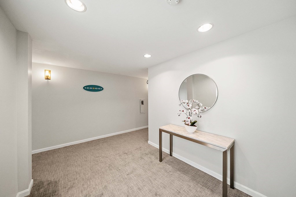 20 Rockland House Road, Unit 406 Hull, MA 02045 - Photo 4 of 39 an empty room with mirror