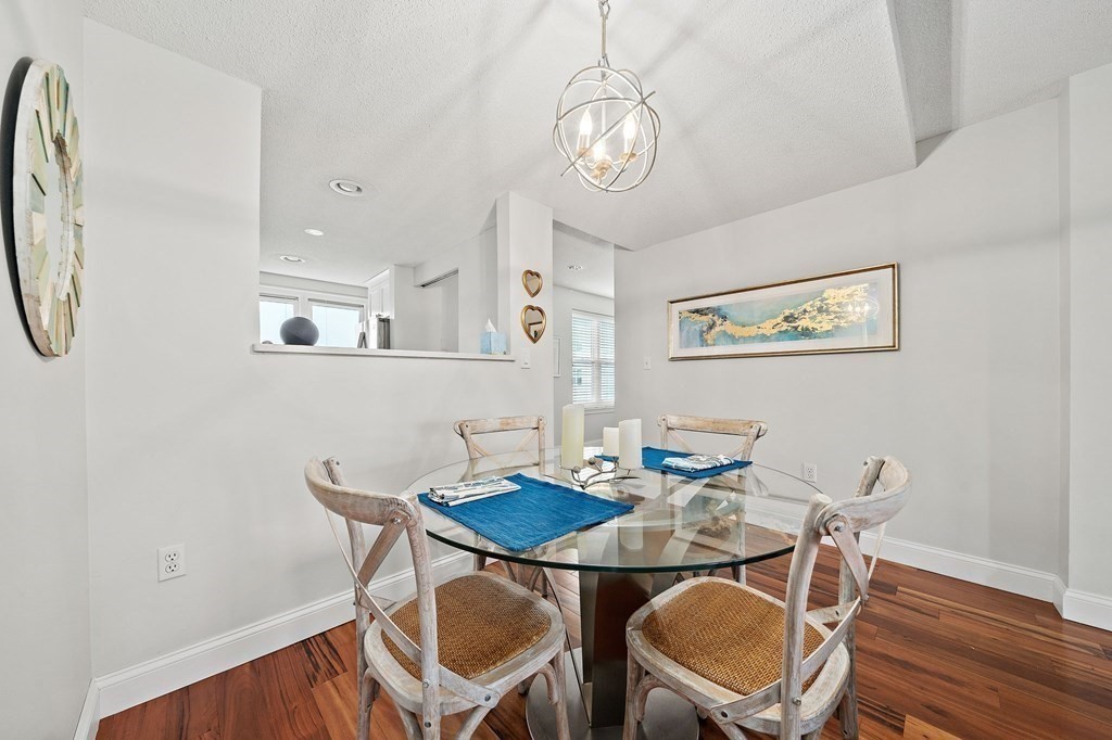 20 Rockland House Road, Unit 406 Hull, MA 02045 - Photo 7 of 39 a view of a dining room with furniture and wooden floor