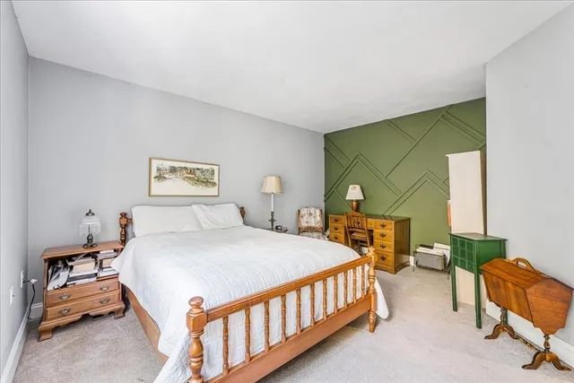 a bedroom with a bed a couch and a window