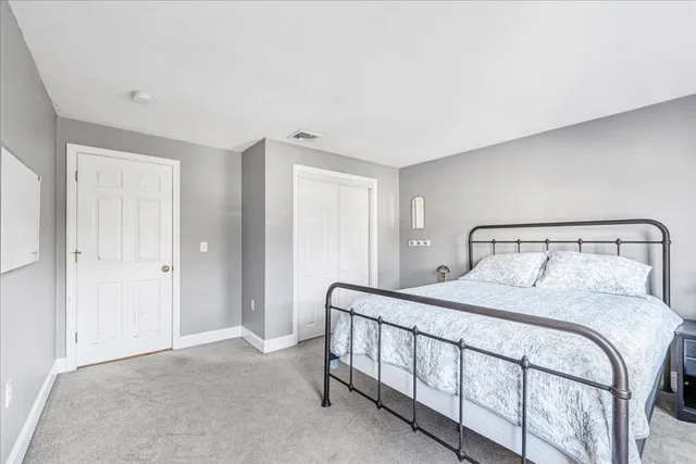 a bedroom with a bed and a night lamp