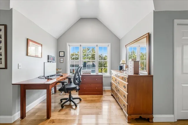 a view of a workspace with furniture and a window