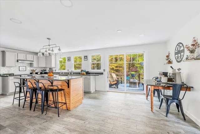 a room with lots of table chair and wooden floor