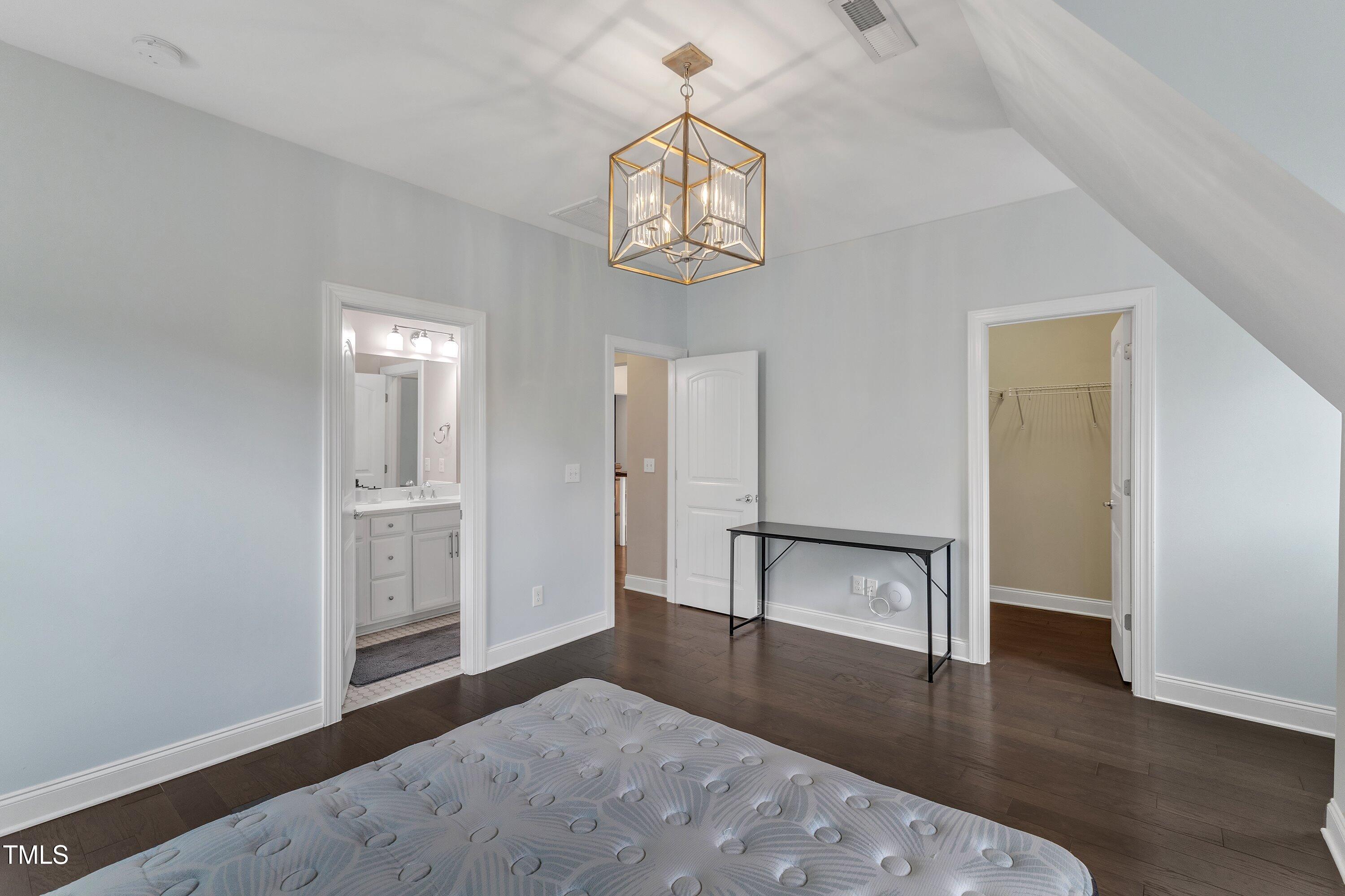 8121 Greys Landing Way Raleigh, NC 27615 - Photo 51 of 95 an empty room with wooden floor fan and windows