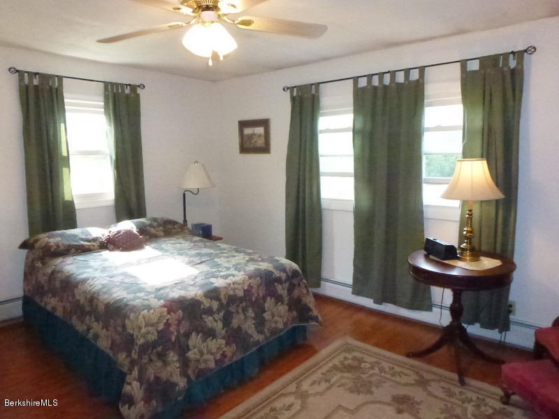 148 Mohawk Trail Florida, MA 01247 - Photo 17 of 18 a bedroom with a bed and a table
