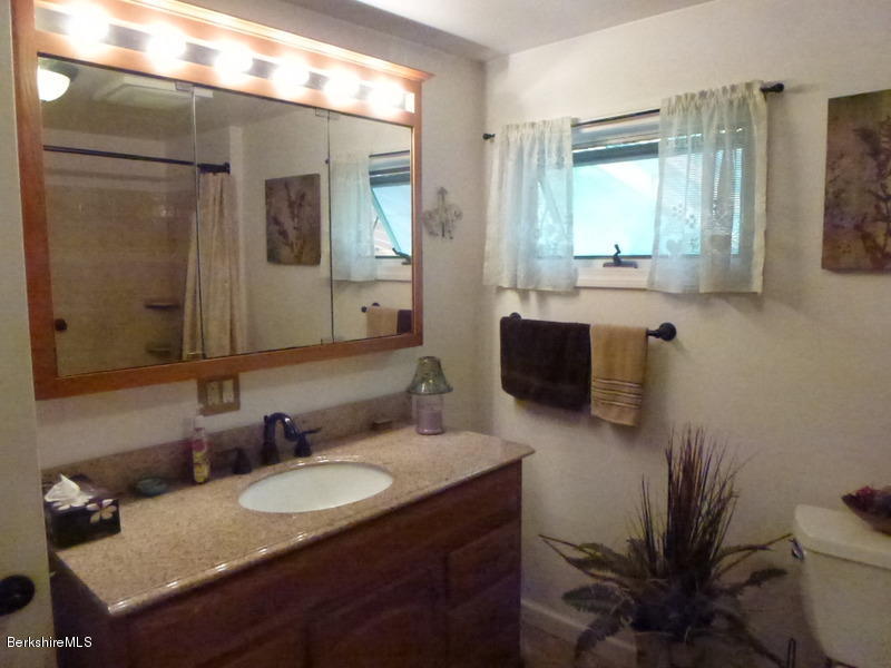 148 Mohawk Trail Florida, MA 01247 - Photo 10 of 18 a bathroom with a granite countertop sink a toilet and mirror