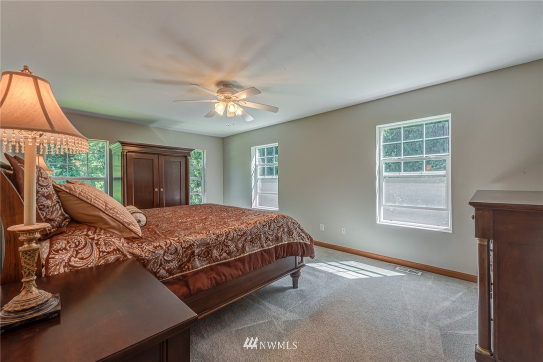16108 OK Mill Road Snohomish, WA 98290 - Photo 11 of 23 a bed sitting in a bedroom next to a window