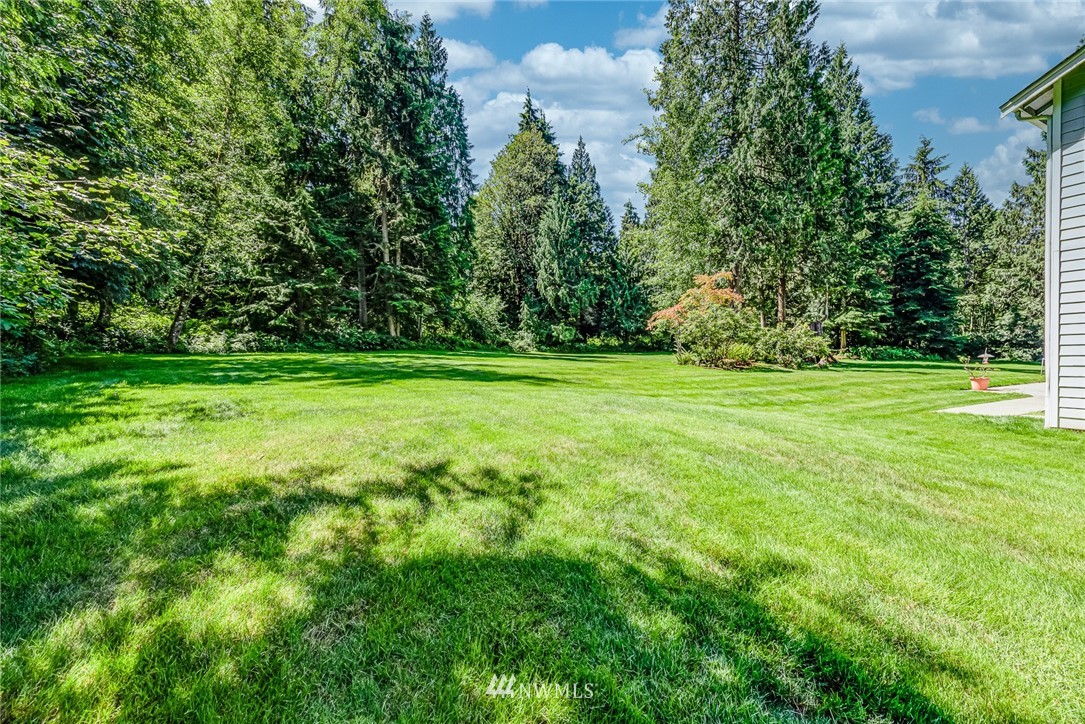 16108 OK Mill Road Snohomish, WA 98290 - Photo 19 of 23 a view of a grassy field with trees in the background